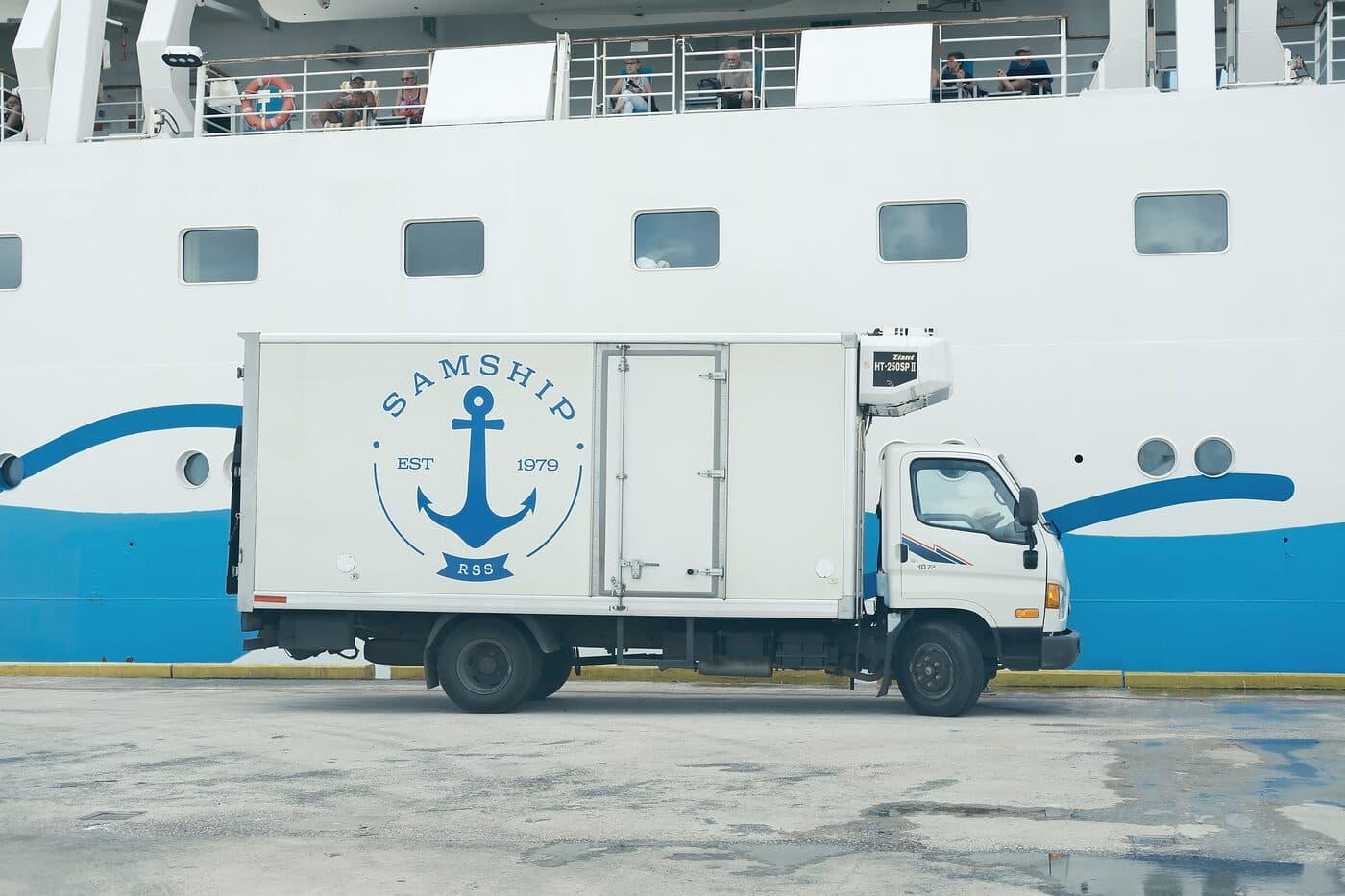 A Samship refrigerated truck parked alongside a cruise ship's hull