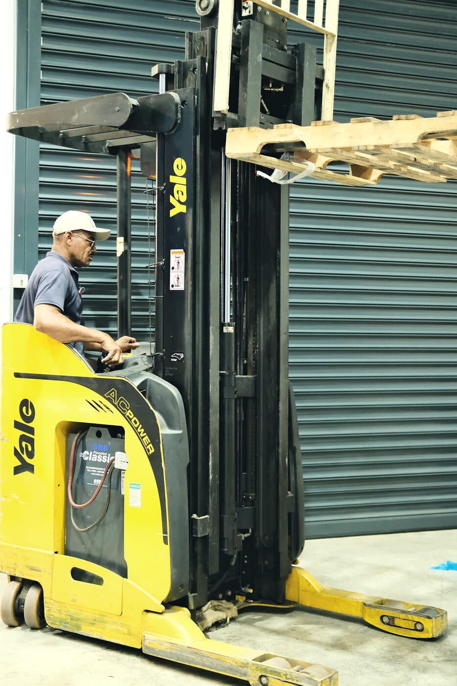 A Samship operator handling a pallet with a reach truck in the warehouse